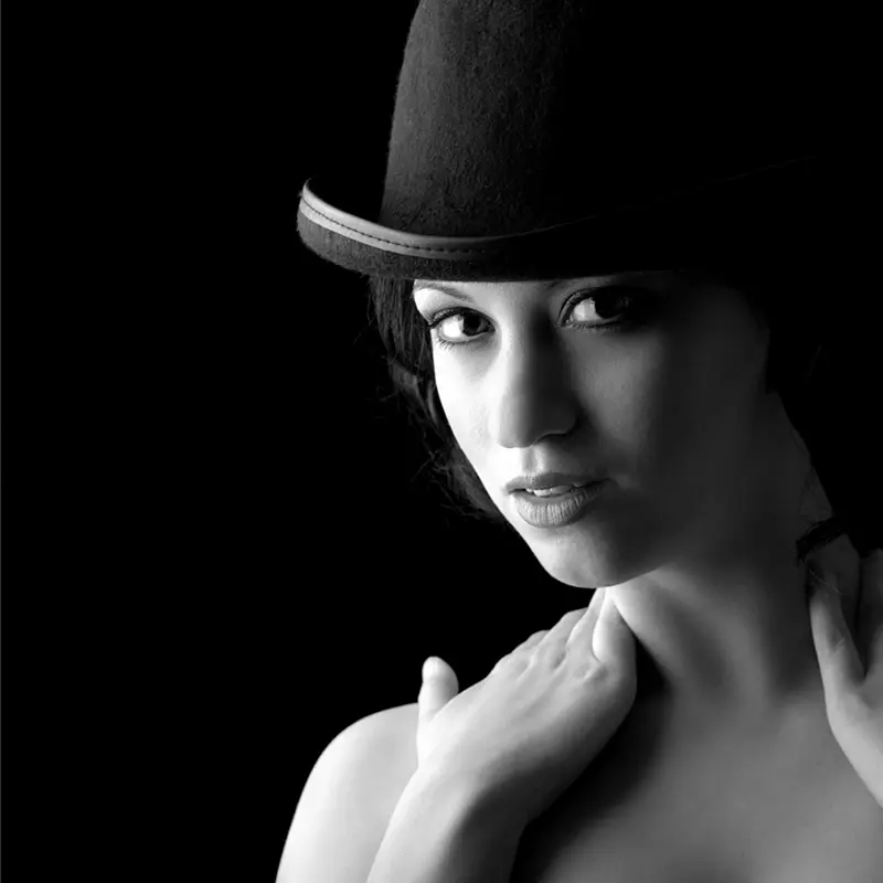 Black and white image of a woman head and shoulders wearing a Bowler hat