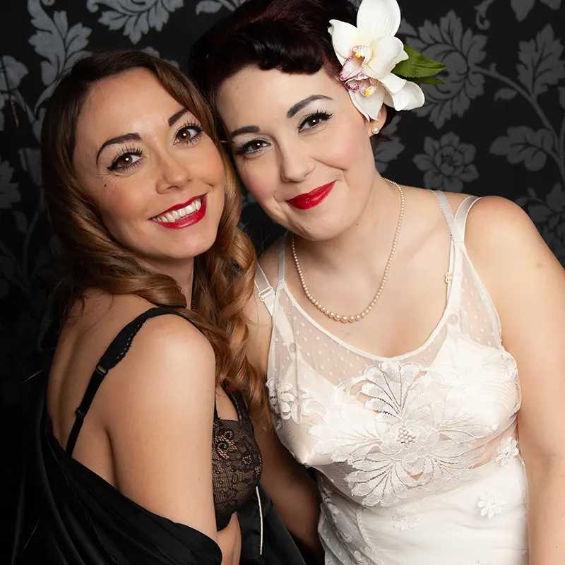 Close up of two sisters wearing vintage lingerie